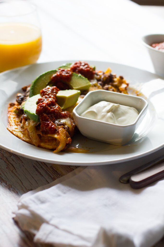 A spicy mexican chorizo omelet, jam-packed with chorizo, onions and peppers and topped with cheese, avocado and salsa. Based on my favorite breakfast dish, the Hey Lucy!