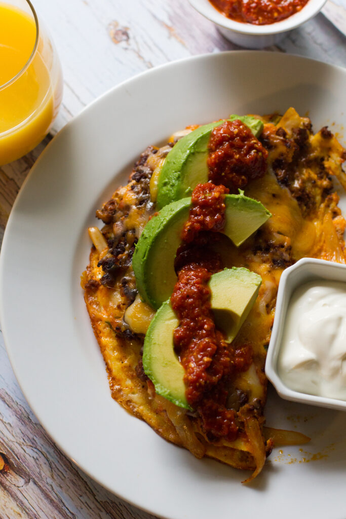 A spicy mexican chorizo omelet, jam-packed with chorizo, onions and peppers and topped with cheese, avocado and salsa. Based on my favorite breakfast dish, the Hey Lucy!