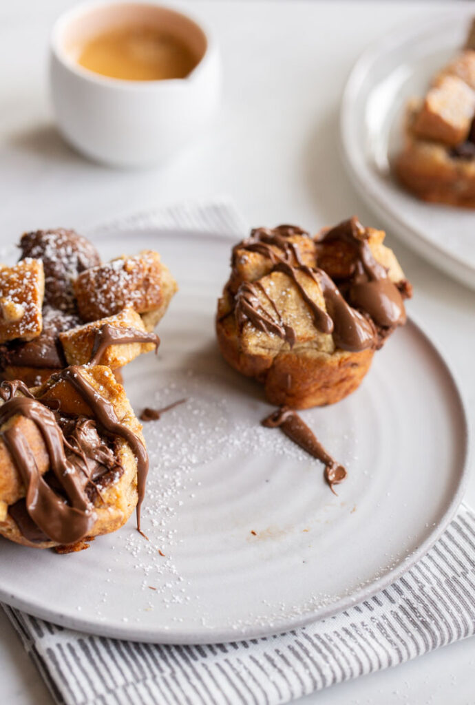 french toast cups stuffed with nutella and topped with more nutella and powdered sugar