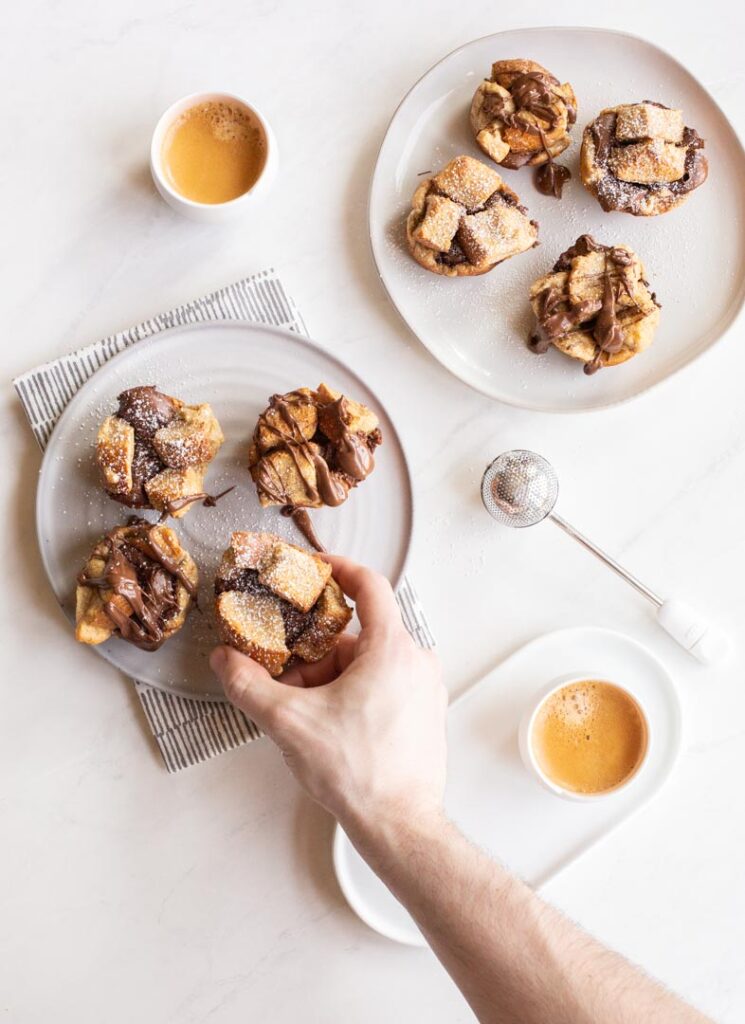 french toast cups stuffed with nutella and served with coffee and a dusting of powdered sugar