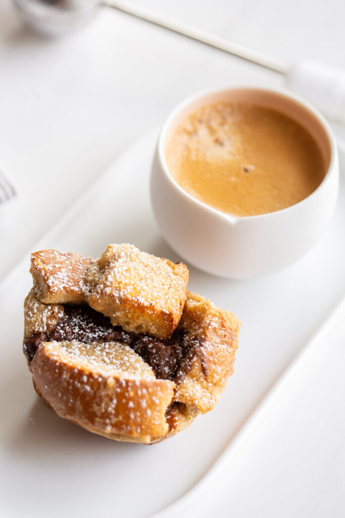 french toast cups stuffed with nutella and dusted with powdered sugar and served with espresso