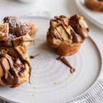 French toast cups are a fantastic easy to make breakfast. Pop them in the oven and continue your morning as they bake. The Nutella hazelnut spread takes these over the top!