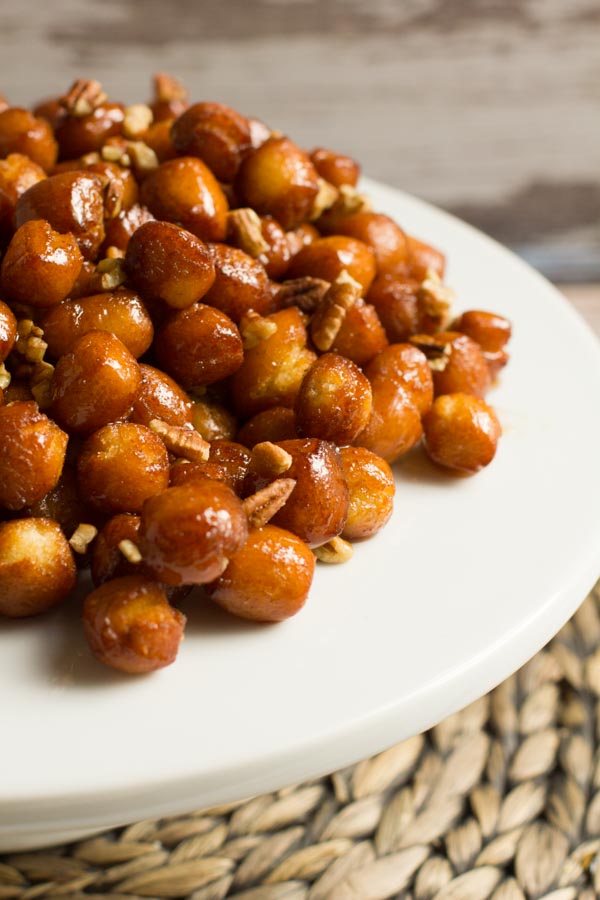 Not Your Nana's strufoli. These deep fried honey balls are made different with a maple bourbon glaze and tossed with pecans.