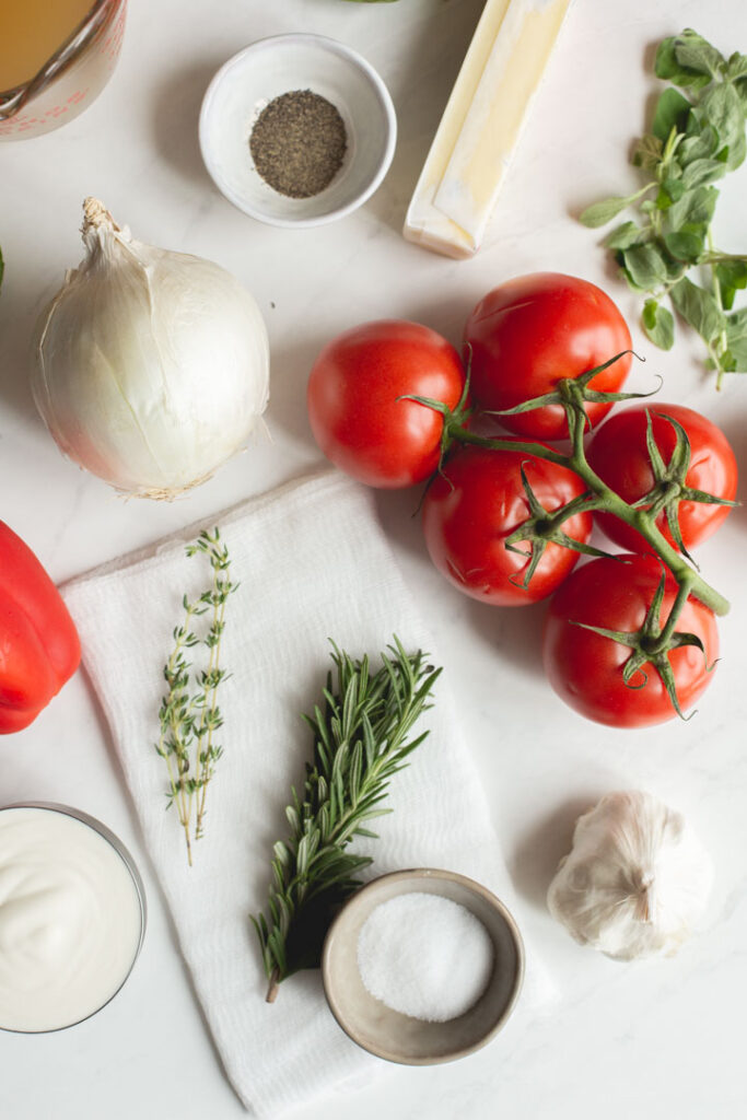 the ingredients for roasted red pepper and tomato soup sitting on a table