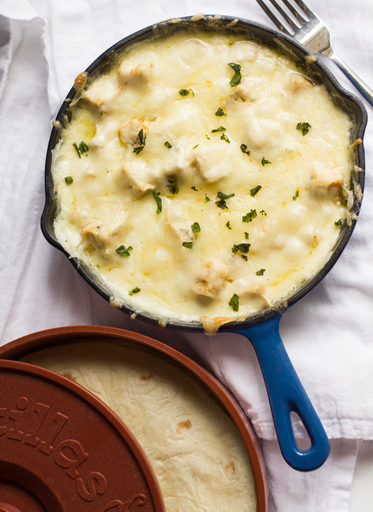 A delicious Tex-Mex appetizer, queso flameado is a warm bowl of cheese and meat served in tortillas.