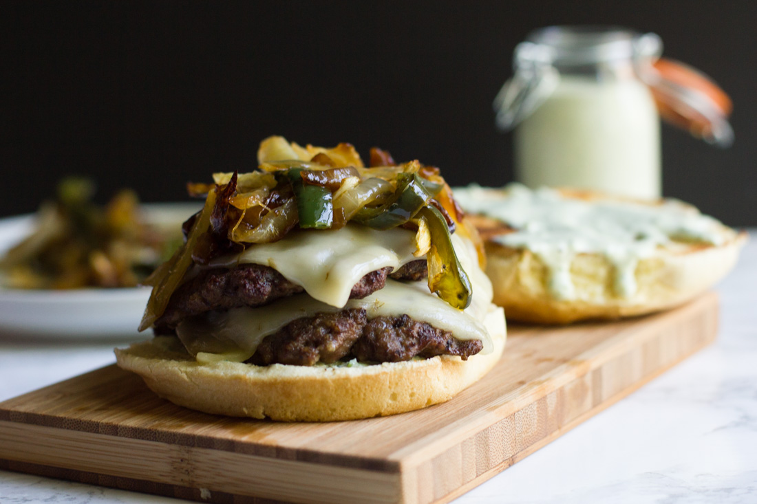 A copycat recipe of a fast food favorite: the Monterey Melt. It's a juicy burger piled high with cheese, grilled peppers and onions and jalapeno ranch.