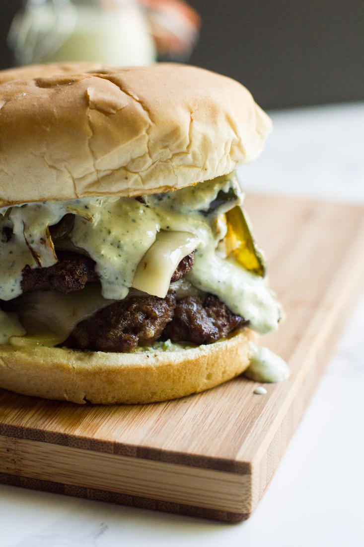 A copycat recipe of a fast food favorite: the Monterey Melt. It's a juicy burger piled high with cheese, grilled peppers and onions and jalapeno ranch.