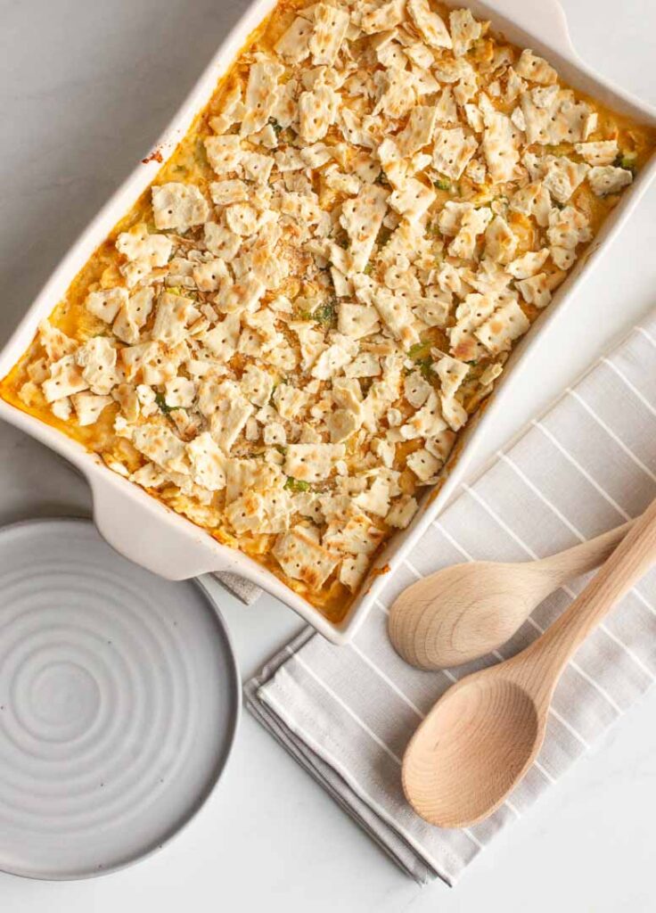 broccoli cheddar casserole topped with crackers on a table