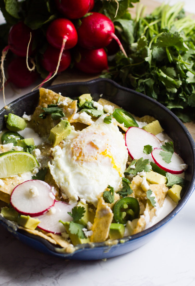 Chilaquiles verdes are a tex-mex brunch mainstay. Tossed in salsa verde and topped with an egg, cream and cheese, they're the perfect way to start your day.