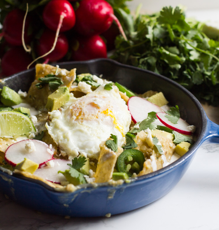 Chilaquiles verdes are a tex-mex brunch mainstay. Tossed in salsa verde and topped with an egg, cream and cheese, they're the perfect way to start your day.