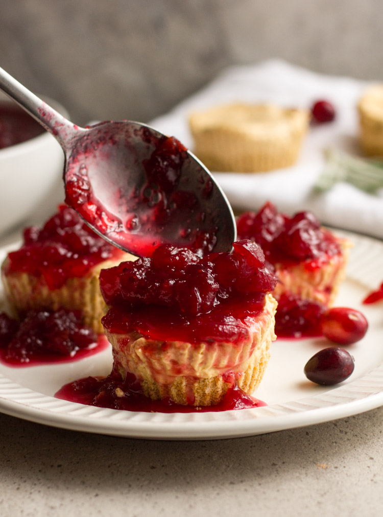 No bake pumpkin cheesecakes make party planning a breeze. Prep these mini cheesecakes and the cranberry topping ahead and chill in the fridge until the big day. Perfect for Thanksgiving and the holiday season. #ad