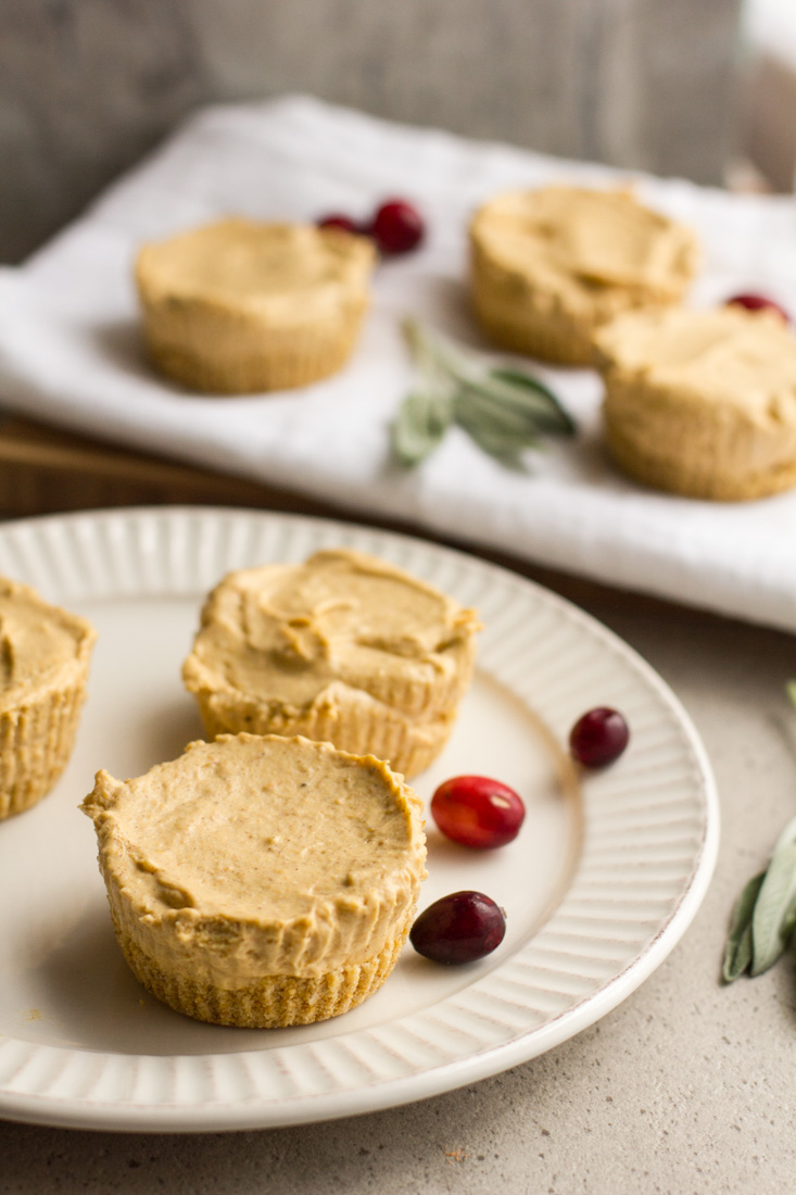 No bake pumpkin cheesecakes make party planning a breeze. Prep these mini cheesecakes and the cranberry topping ahead and chill in the fridge until the big day. Perfect for Thanksgiving and the holiday season. #ad