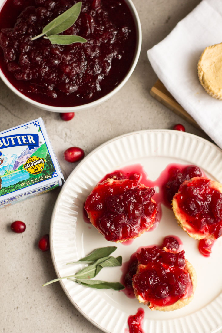 No bake pumpkin cheesecakes make party planning a breeze. Prep these mini cheesecakes and the cranberry topping ahead and chill in the fridge until the big day. Perfect for Thanksgiving and the holiday season. #ad