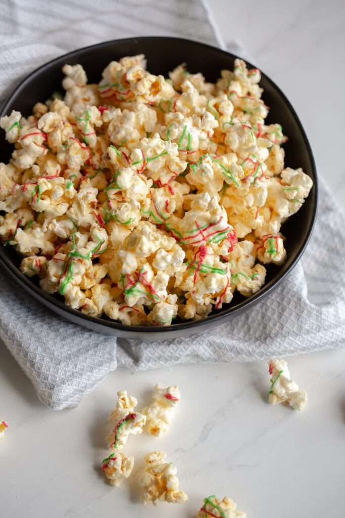 This sweet and salty popcorn recipe is made using white chocolate. It makes the perfect movie night snack, party favor, or christmas gift!