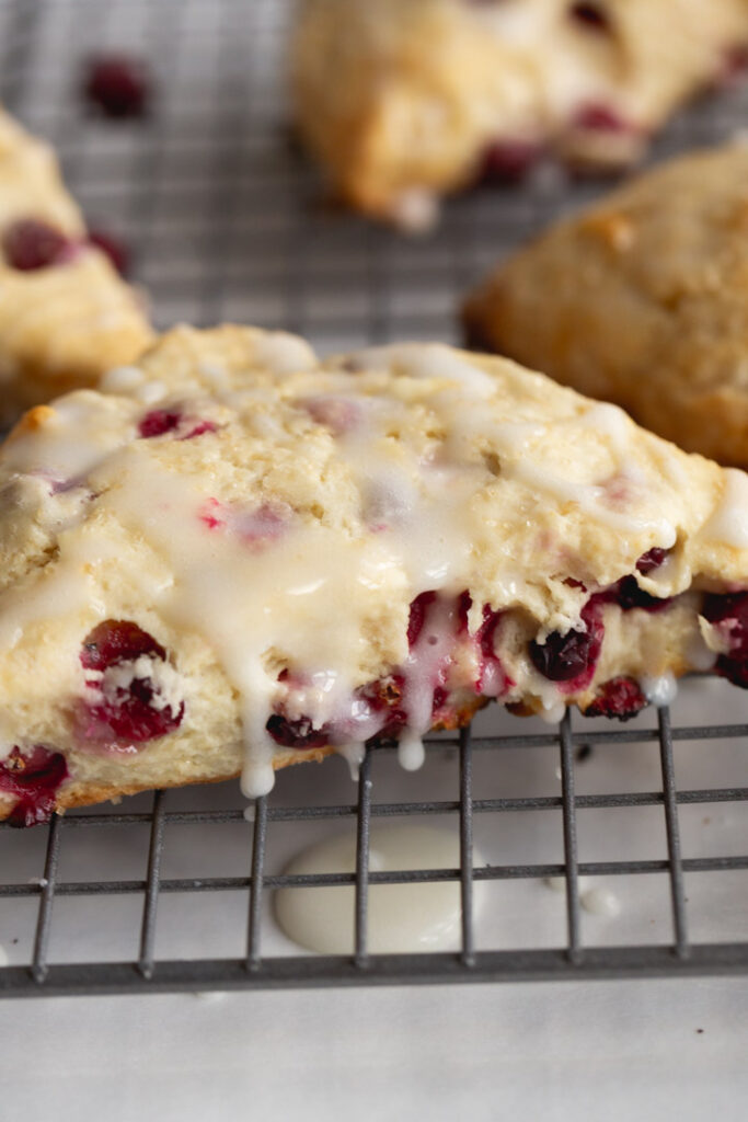 cranberry scone on a cooling rack with glaze