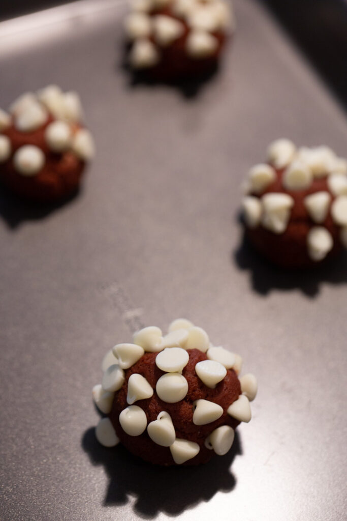red velvet cookie dough rolled in white chocolate chips