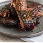 The secret to awesome smoked ribs lies in the technique. Find out how to smoke ribs on a charcoal grill that are tender and so delicious!