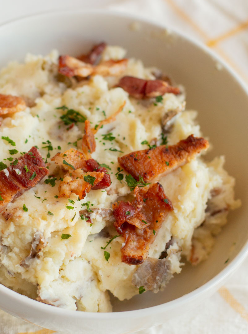 Instant Pot Jalapeno Popper Mashed Potatoes in a bowl with bacon and parsley on top