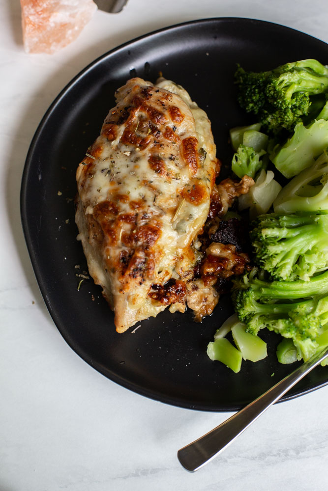 Spinach artichoke stuffed chicken on a plate