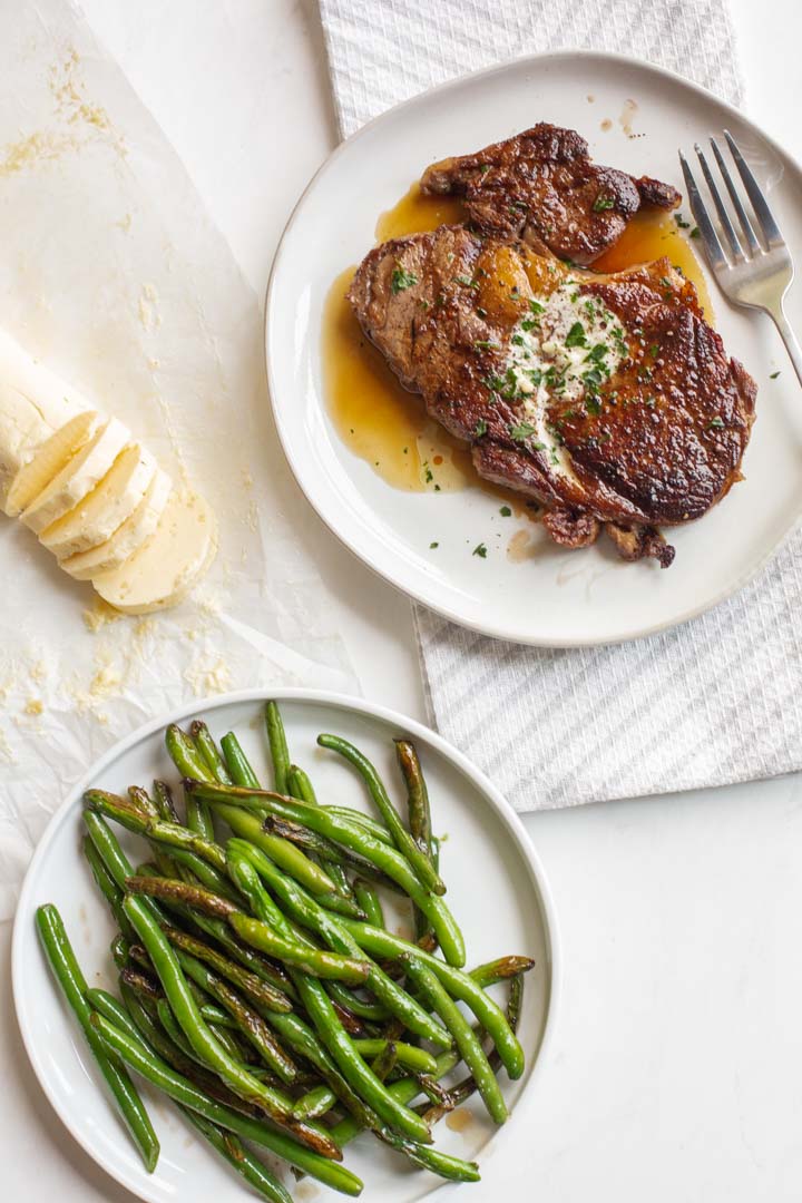 homemade garlic butter sliced and served with steak and green beans