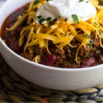 Instant Pot Chili is an easy one pot dish. This recipe uses beef, beans, salsa and spices to give it a truly awesome taste - perfect for tailgating, serving at a bbq cookout, topping chili dogs or as frito pie!