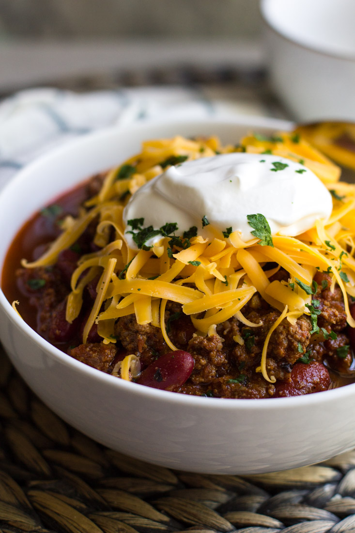 Instant Pot Chili in a bowl with cheese and sour cream