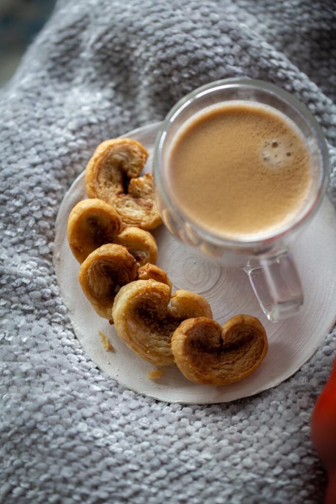 pumpkin spice palmiers on a plate with coffee