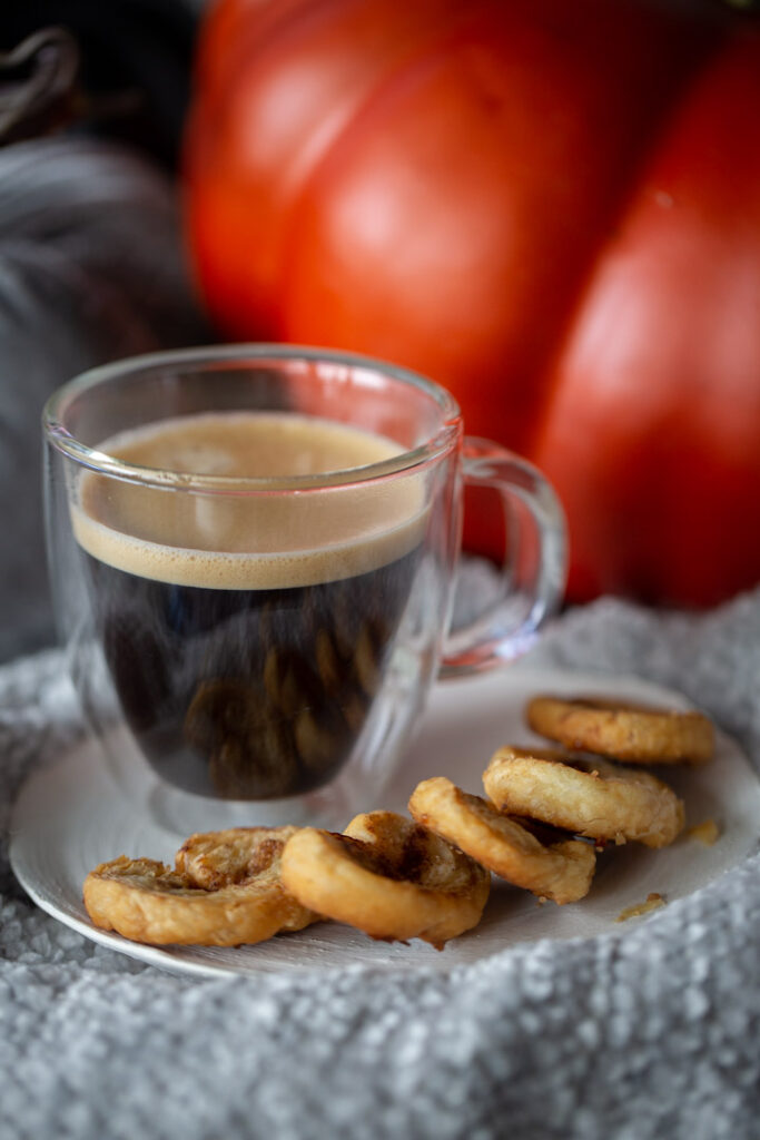 pumpkin spice palmiers on a blanket with a cup of coffee