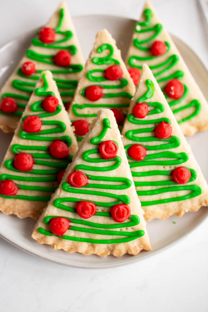 christmas tree cookies made with scottish shortbread and topped with red and green icing