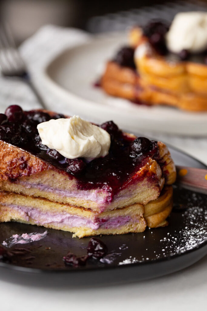 stuffed french toast with the blueberry cream cheese filling showing