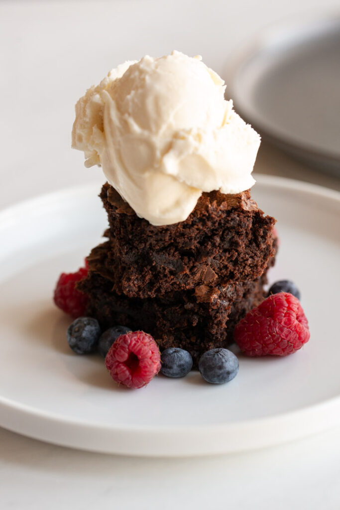 brownies ice cream and fruit on a plate