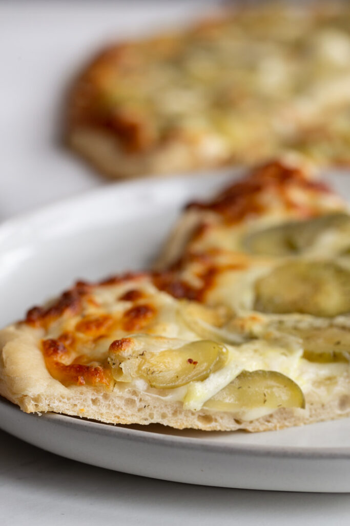 The best pizza needs the best pizza dough. This yeasty pizza dough recipe is soft and chewy with a crispy edge and requires very little kneading!