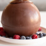 The hugely trendy Melting Chocolate Ball Dessert is a tower of brownie, ice cream and fruit. Top it with the chocolate ball and pour some hot fudge on top to get this showstopper dessert!