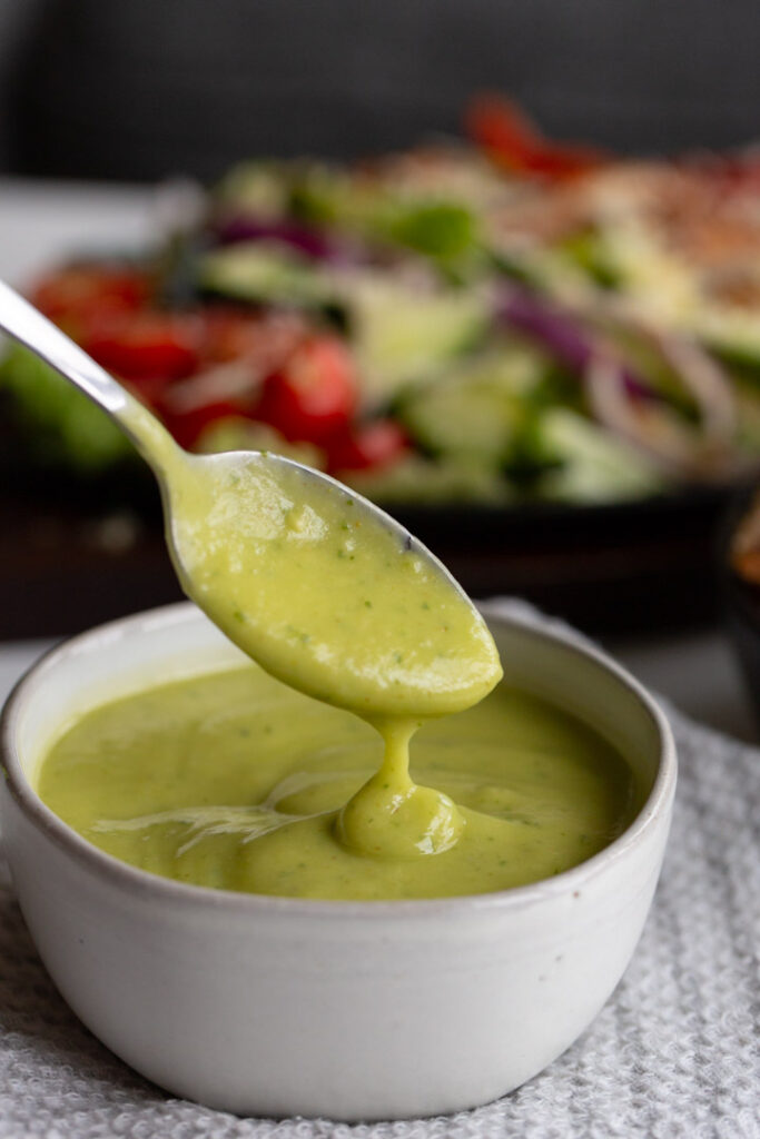 avocado lime dressing scooped out with a spoon