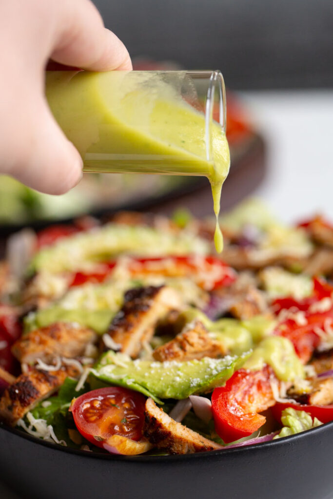 avocado lime dressing poured over a salad