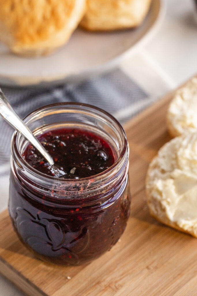 mixed berry jam in a jar with a spoon
