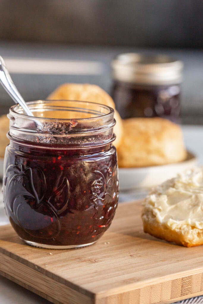 mixed berry jam made from summer fruits in a jar with a spoon