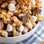 S'mores popcorn is a fun twist on traditional popcorn with marshmallows, chocolate covered grahams and a dusting of cocoa. Perfect for snacking on summer movie nights!