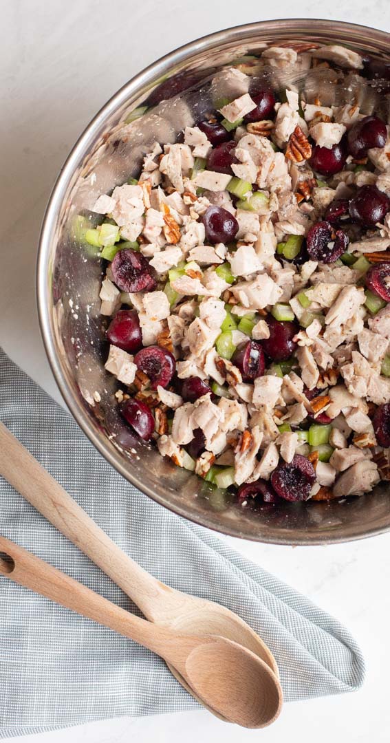 cherry chicken salad mixture with chicken, celery, cherries and pecans in a bowl