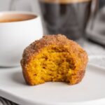 Super easy pumpkin muffins baked and rolled in cinnamon sugar. Perfectly paired with a morning coffee, they're soft, dense, and bursting with flavor!