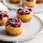 These mini pumpkin cheesecakes are moist and fluffy, full of pumpkin pie flavor then topped with a cranberry and pecan compote and white chocolate. They're the ultimate Thanksgiving and fall dessert!