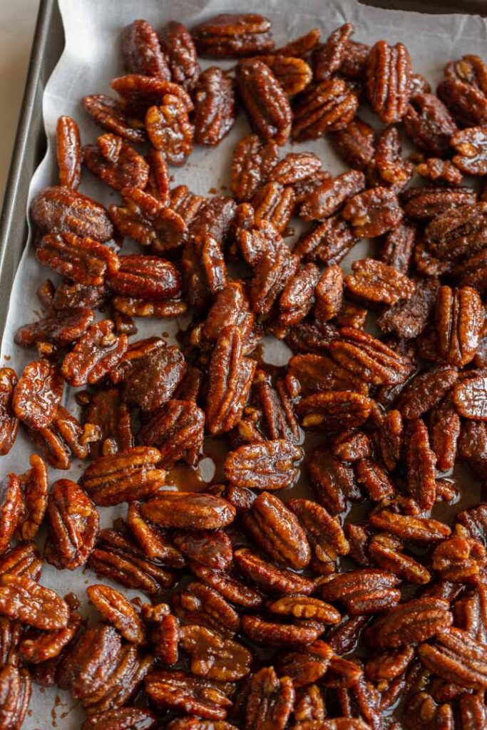 spicy candied pecans drying on parchment