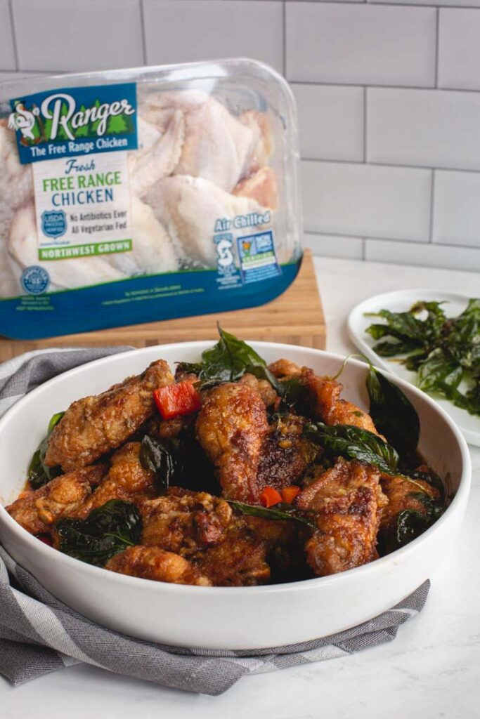 crispy chicken wings tossed in a garlic sauce in a bowl