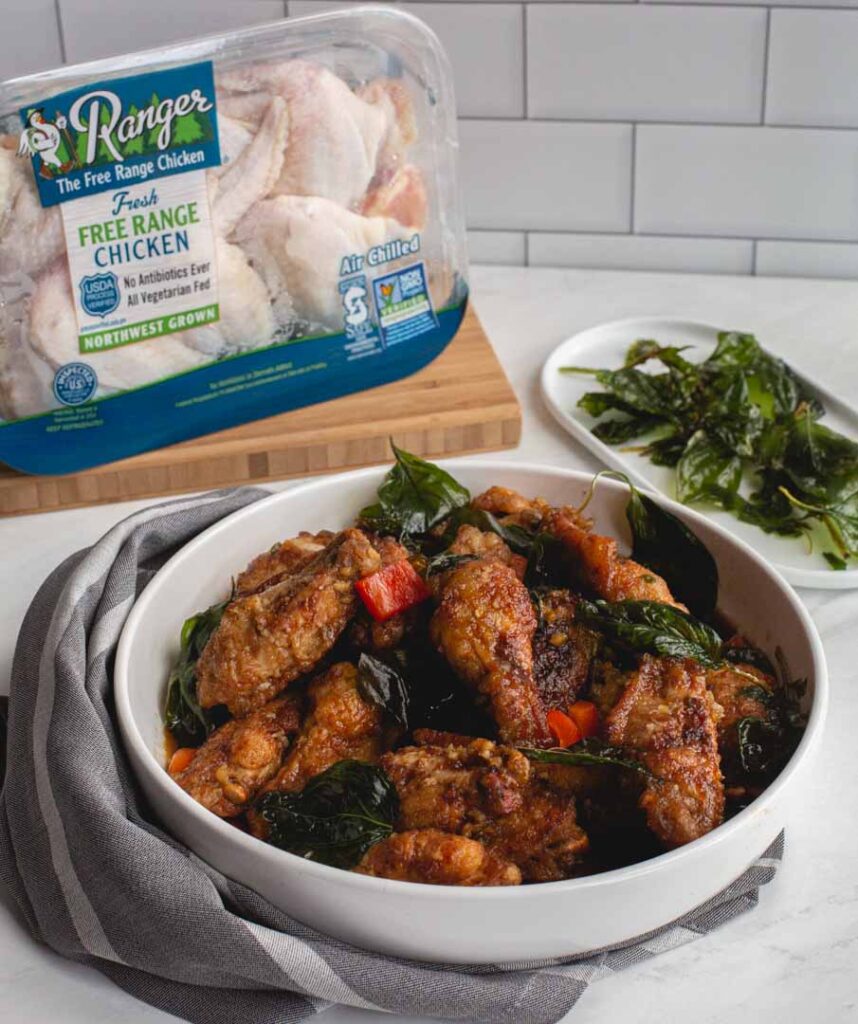 crispy garlic chicken wings with a package of chicken in the background