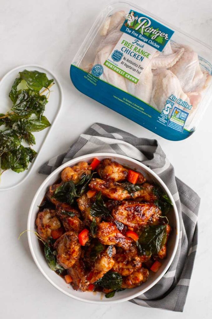 top down view of chicken wings tossed in a garlic sauce in a bowl