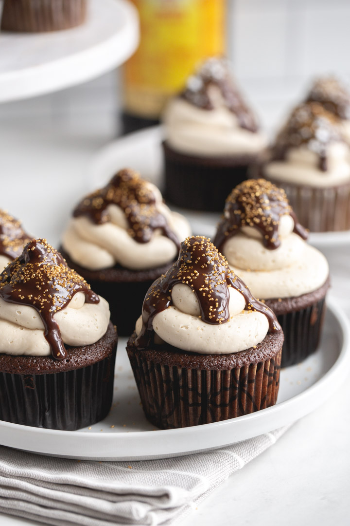 kahlua cupcakes on a plate with frosting and chocolate ganache and sprinkles
