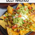 These restaurant style beef nachos are a great way to celebrate all trash fires in life: with chips, seasoned beef, cheese, and more, baked easily in cast iron or on a sheet pan in the oven. Top it with a spicy homemade green fire sauce.