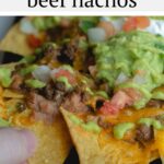 These restaurant style beef nachos are a great way to celebrate all trash fires in life: with chips, seasoned beef, cheese, and more, baked easily in cast iron or on a sheet pan in the oven. Top it with a spicy homemade green fire sauce.